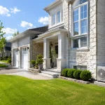 AC replacement Oakville - central air conditioner outside suburban home in summer